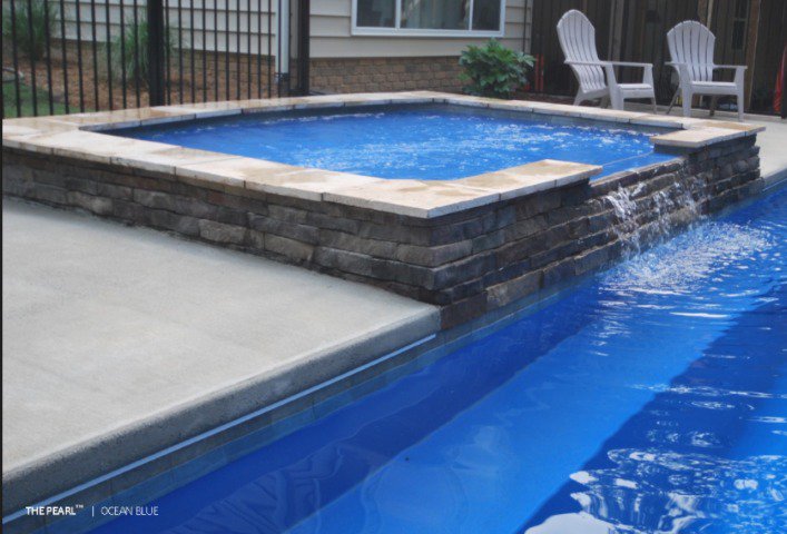 A fiberglass above-ground pool with a tanning ledge.